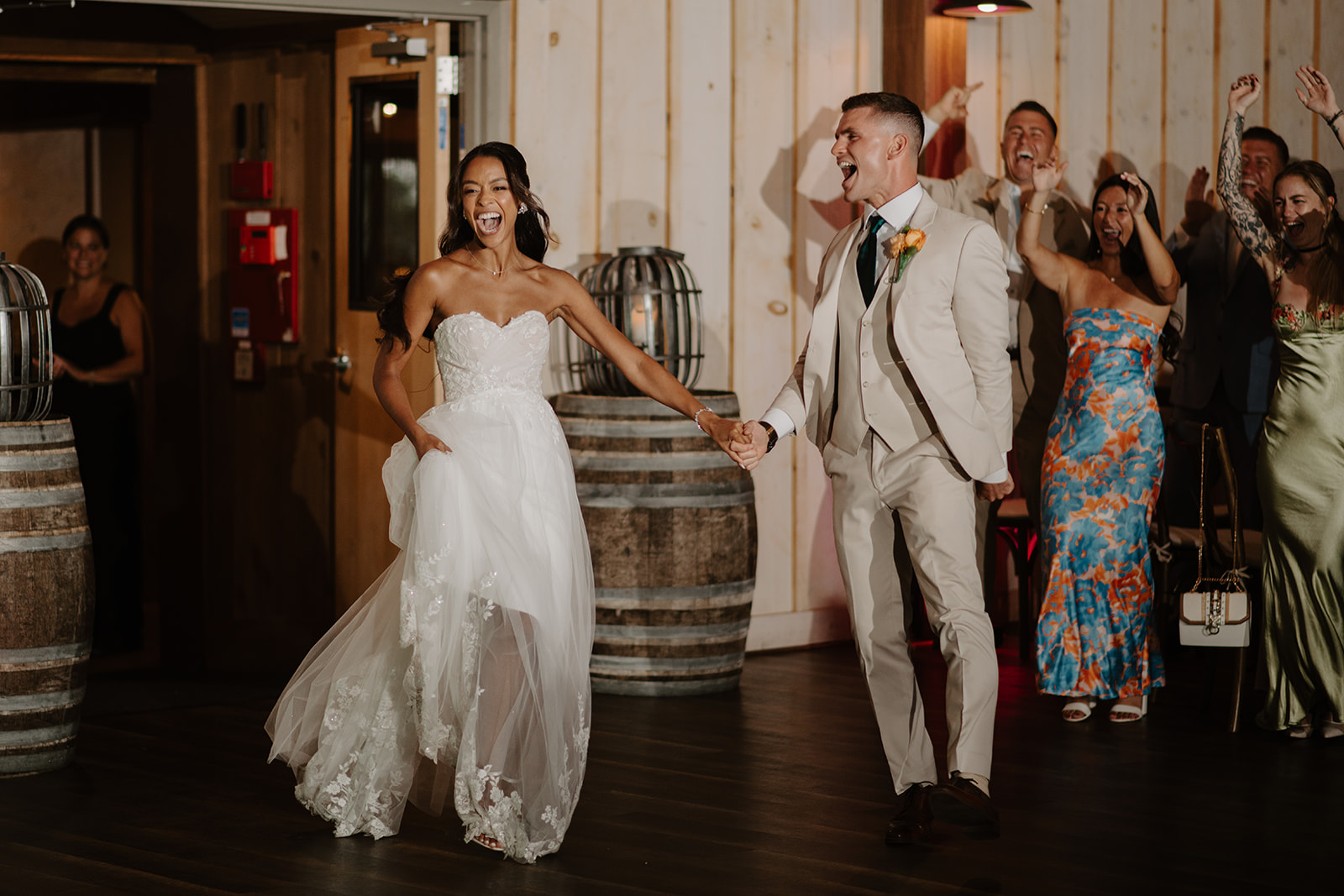 Bride and groom make their grand entrance into the barn reception.