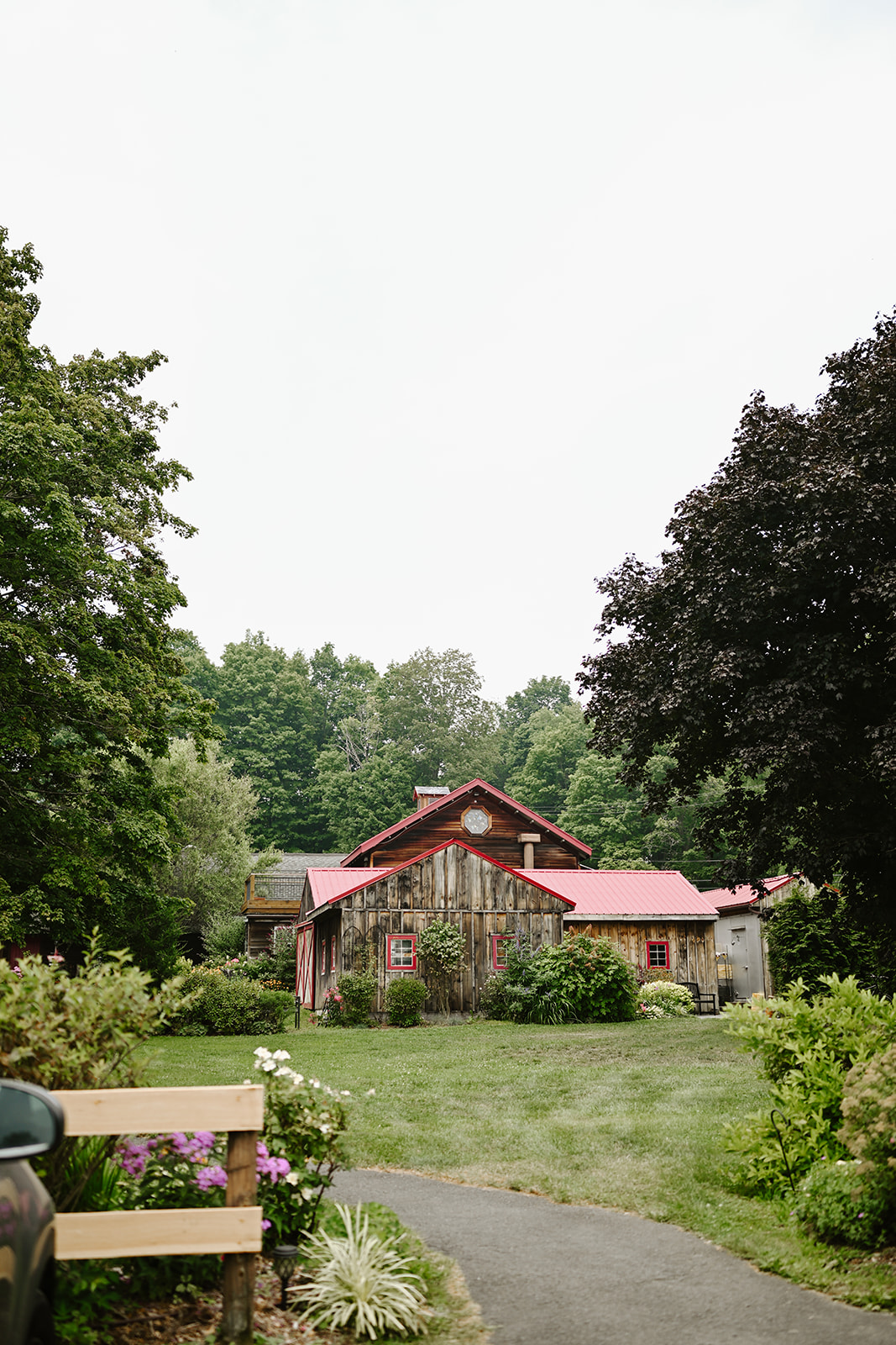 Path leading to the red-roofed barn and gardens at Red Maple Vineyard.
